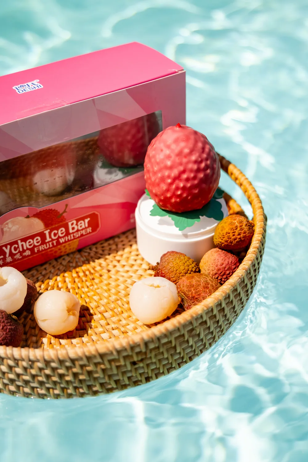 Close view of lychee-shaped novelty ice cream with fruit and packaging