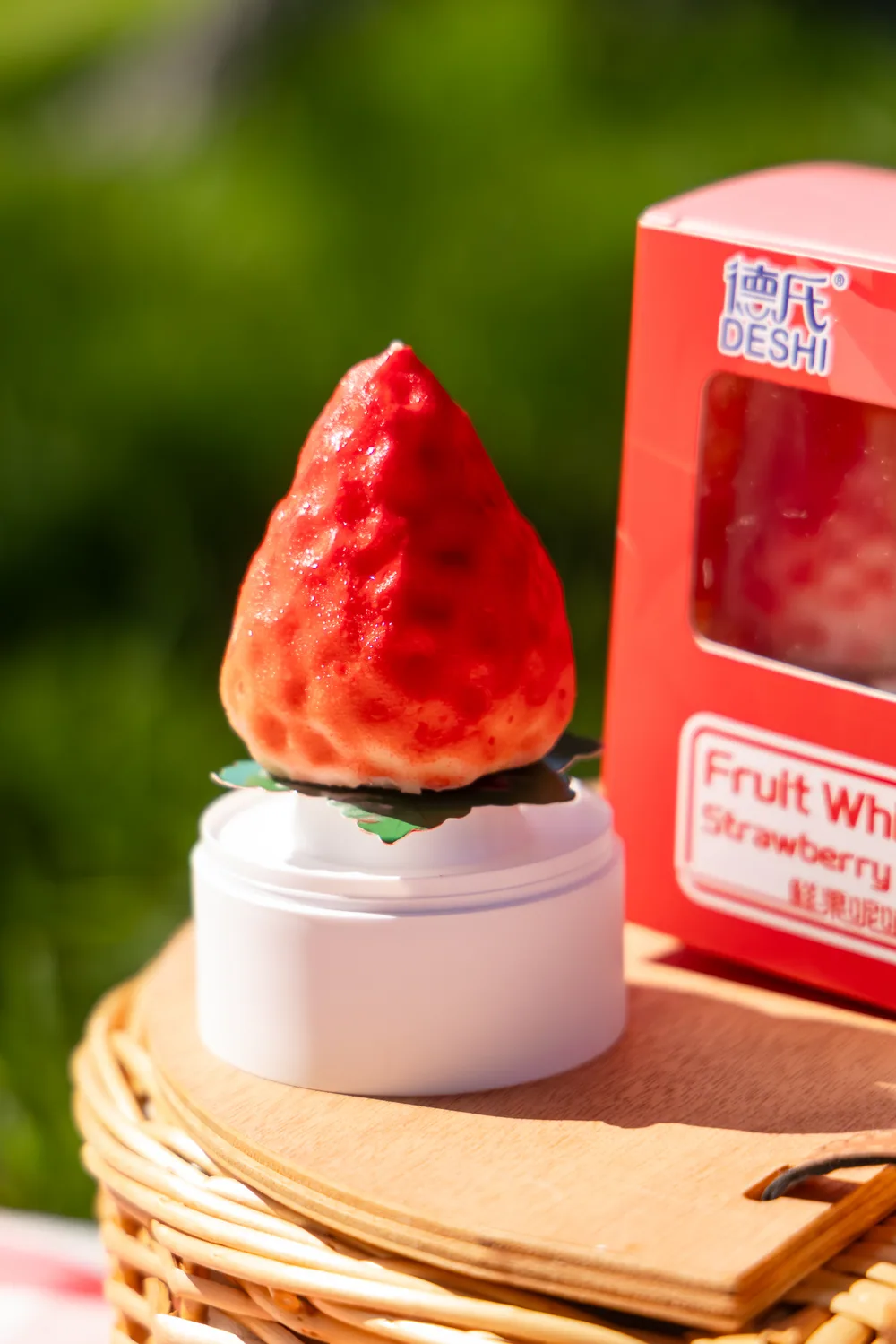 Strawberry-shaped Fruit Whisper ice cream beside its package